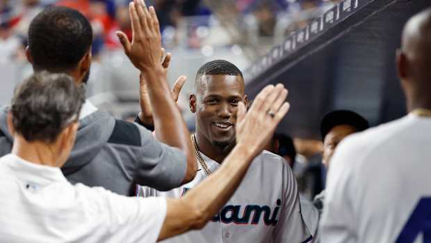 Jorge Soler high fives his teammates.